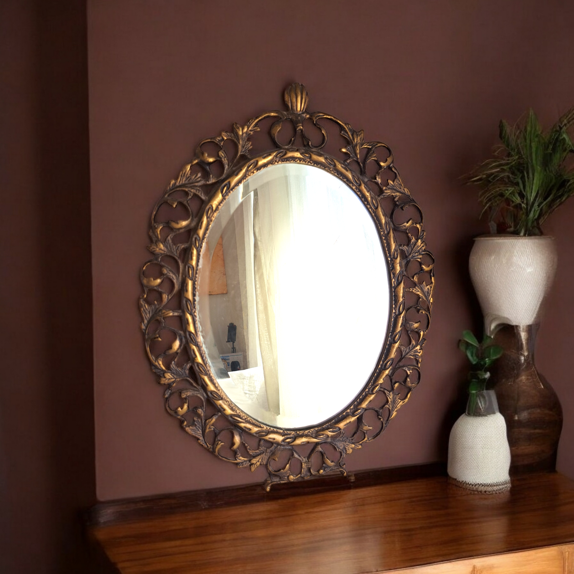 Antique brass mirror can be placed on a table, shelf, or dresser, leaning securely against the surface with its sturdy feet.